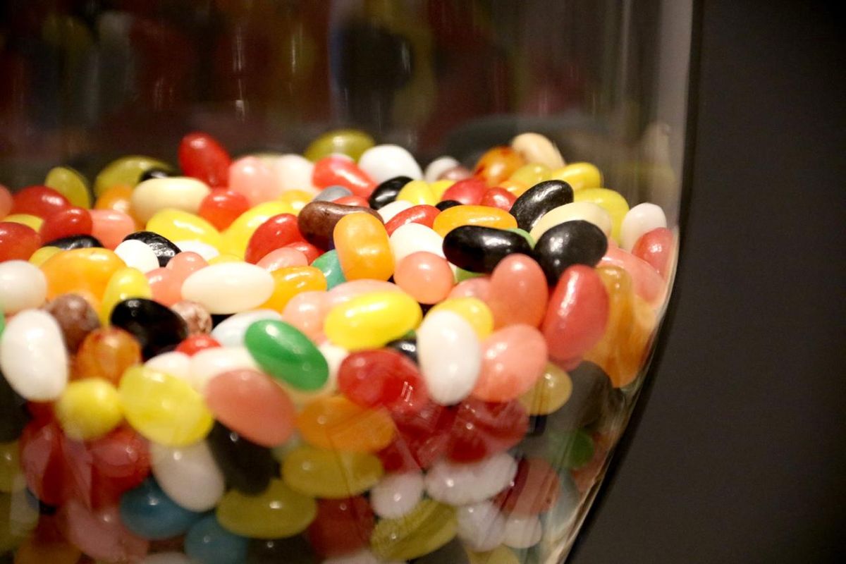A glass jar full of colourful jelly beans